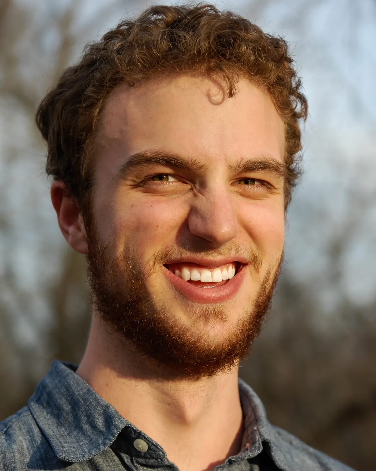 Sean McKeever smiling outdoors in late-afternoon light.